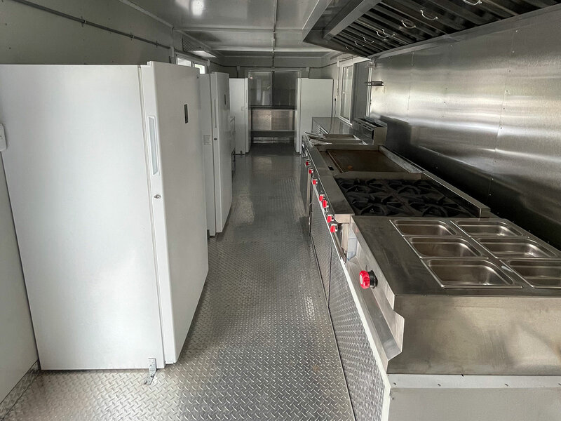 Inside view of food truck with refrigerators and stoves