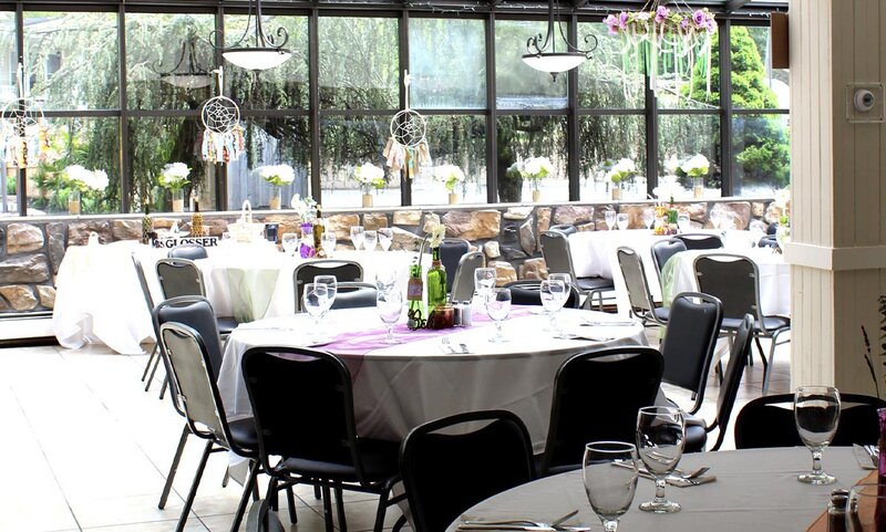 Atrium Room with multiple set tables with view of outside